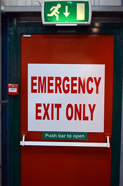 Emergency Exit. Emergency exit only sign attached to door. door fire exit sign swinging doors fire door stock pictures, royalty-free photos & images