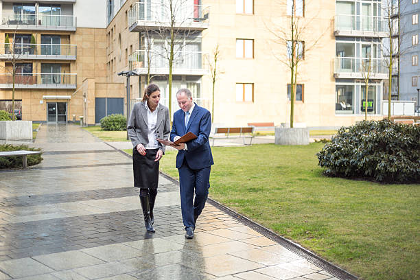 istock Two business people walking and discussing 468960616