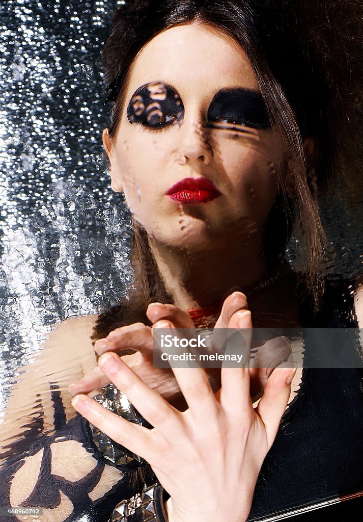 Glam-rock girl Portrait of brunette in the mirror blurred water drops Individuality Stock Photo