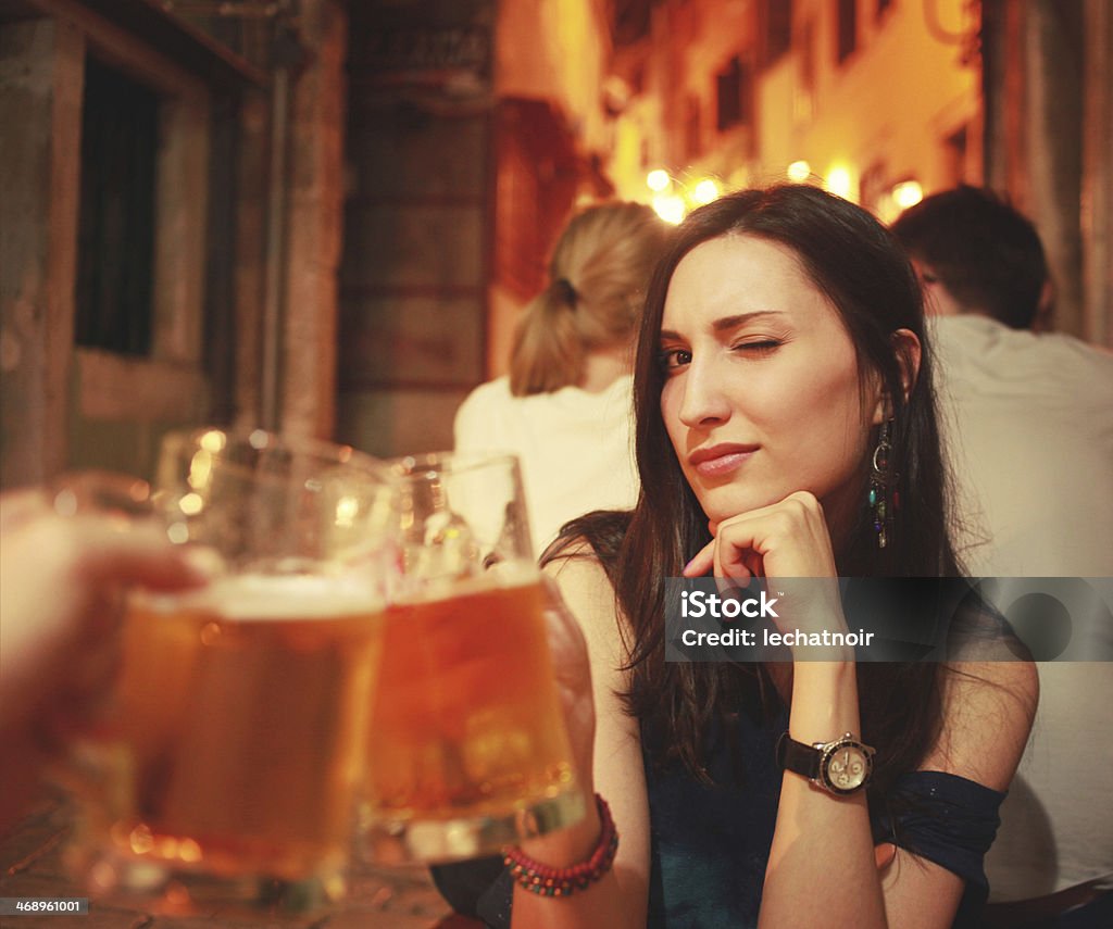 Cheers Pretty brunette celebrating with draft beer.  Adult Stock Photo