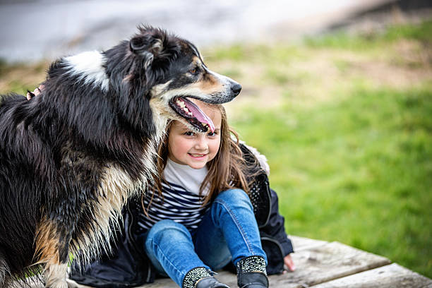 istock Six year old girl on bench with her dog 468961688