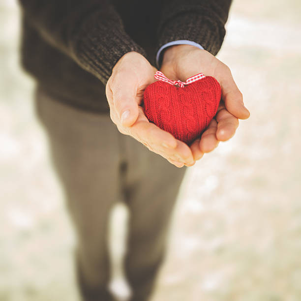 istock holding a puppet red heart for st. valentine 468964623