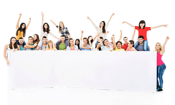 istock Large group of cheerful people holding white banner. 468965475