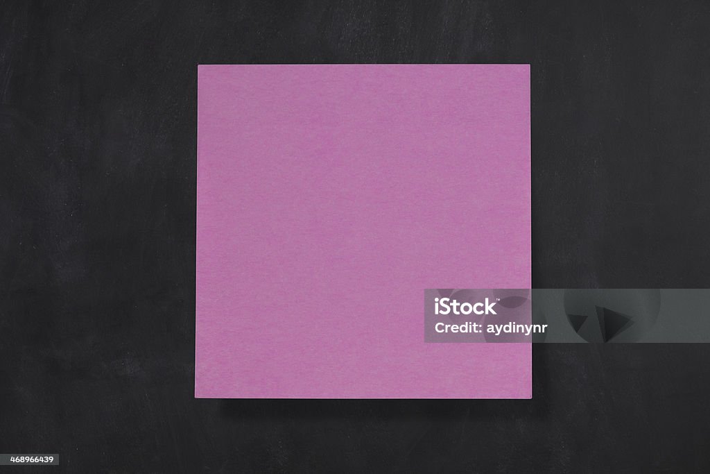 Pink Pink paper on the black chalkboard. Adhesive Note Stock Photo