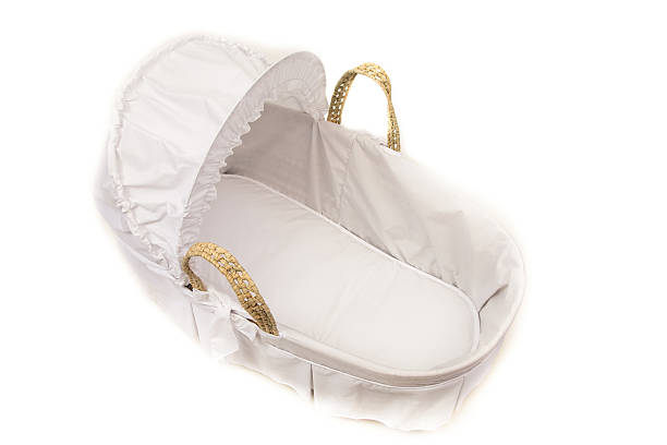 Wicker Moses basket with white cover and hood Wicker Moses basket with white cover with retractable hood raised. moses basket stock pictures, royalty-free photos & images