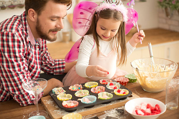 istock Father and daughter baking in kitchen. 468967988