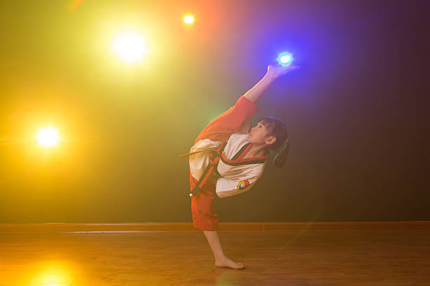 The little girl is practising Taekwondo.