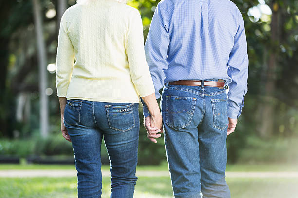 istock Senior couple in the park, walking, holding hands 468968040