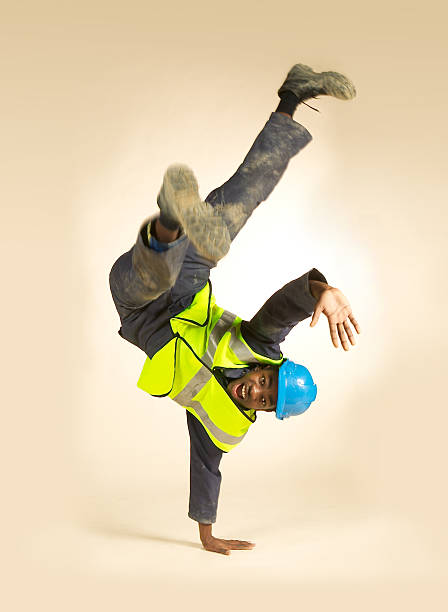 Young construction worker dancing stock photo