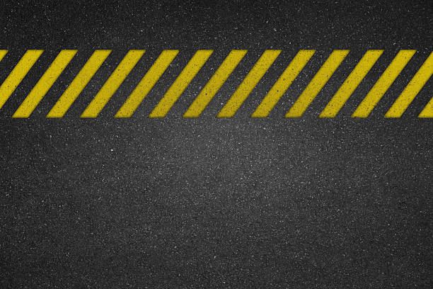 Cautionary yellow line on road texture for backgrounds
