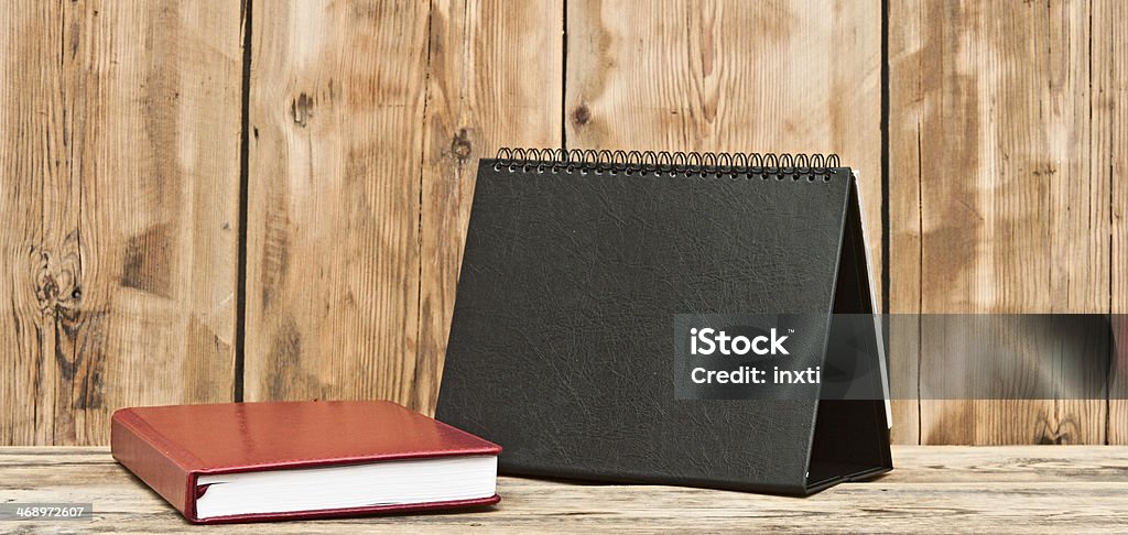 desk calendar with red leather note book on wood table Calendar Stock Photo