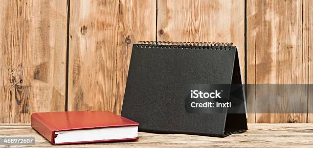 Desk Calendar With Red Leather Note Book On Wood Table Stock Photo - Download Image Now