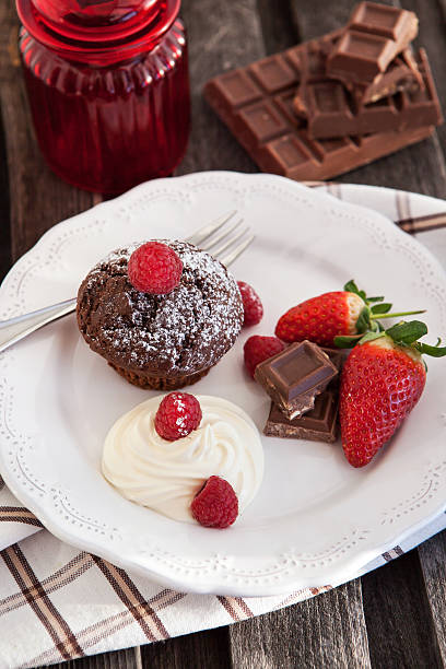 istock Chocolate muffin served with cream and fresh berris 468973081