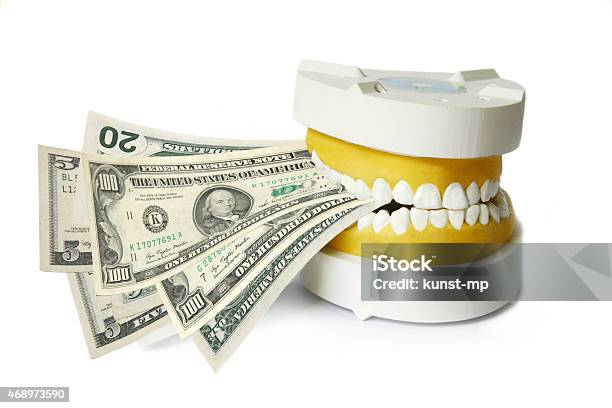 Dentures Biting Dollar Banknotes Stock Photo - Download Image Now - Dental Health, Dental Equipment, Insurance