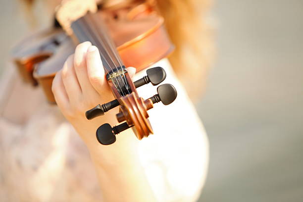 istock Female hand with a violin outdoor 468973793