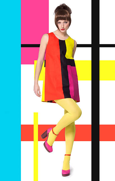 Model In Bright Retro Colors Colorful concept in sixties retro fashion style with Caucasian model posing full body over designed background with colorful bright stripes and color blocks. color block stock pictures, royalty-free photos & images