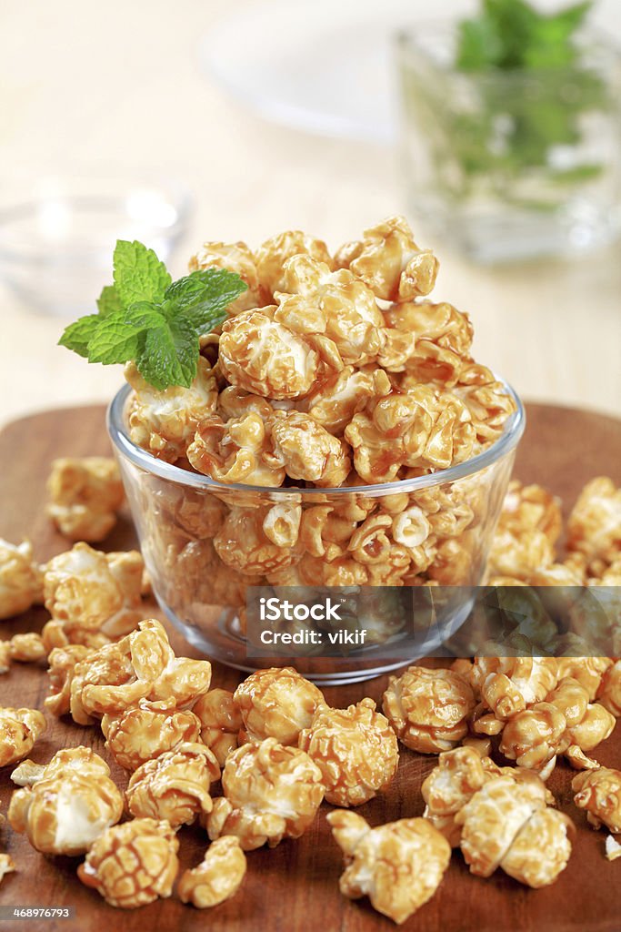 Toffee popcorn Glass bowl of popcorn coated with caramel Brown Sugar Stock Photo
