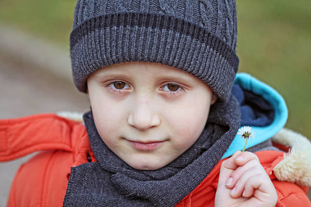 istock The boy holda a little flower in his hand 468977165