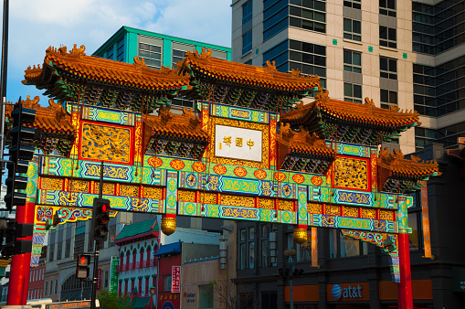 Washington DC, United States - April 22, 2010: The Friendship Archway, built in 1986, serves as the gateway to Washington DC's Chinatown.  Behind the gateway are office buildings and Chinese styled buildings.