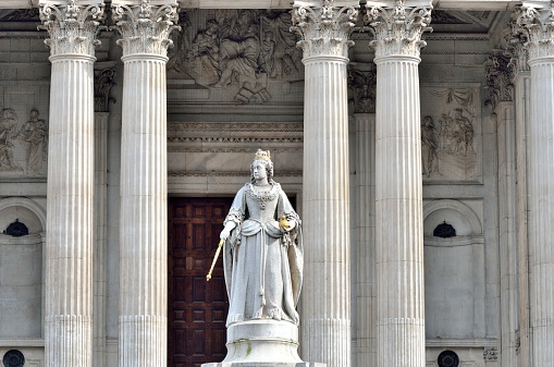 Statue of Queen Victoria in front of St Pauls with four  columns