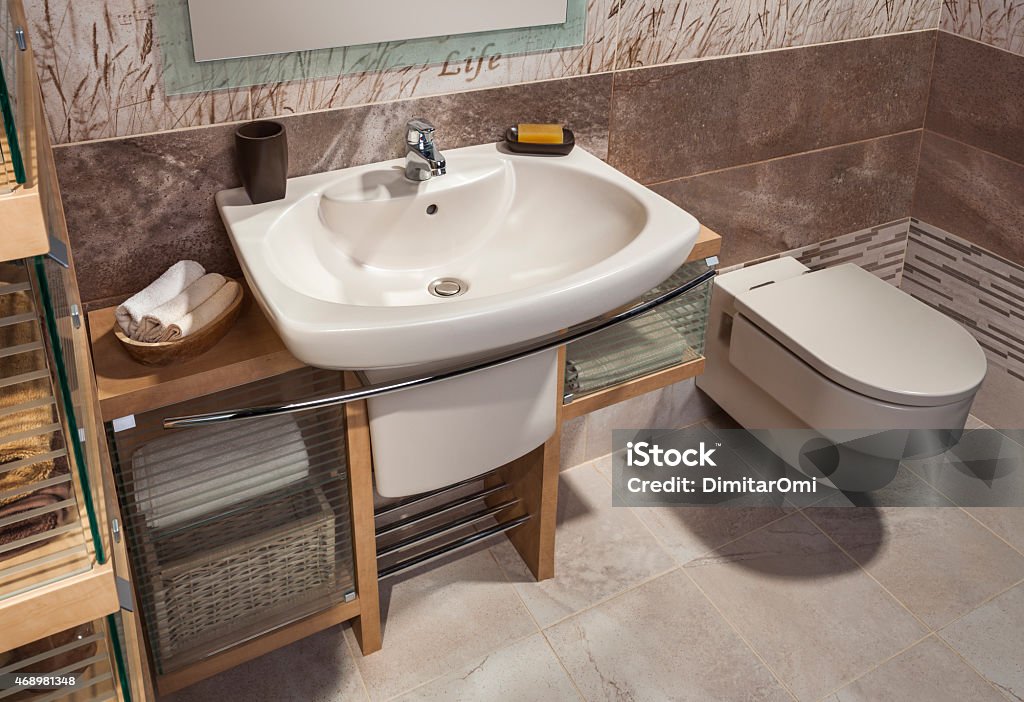 detail of a modern bathroom with sink detail of a modern bathroom with sink, toilet and cabinet 2015 Stock Photo