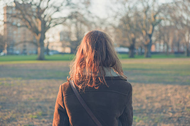 istock Woman walking in park on a winter day 468983954
