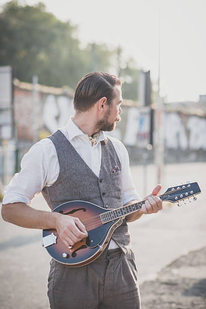 istock handsome big moustache hipster man playing mandolin 468984196