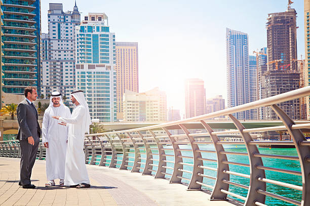 Businessmen struck a deal in Dubai Businessmen struck a deal in Dubai. Shoot from istockalypse Dubai 2015.  dubai marina panorama stock pictures, royalty-free photos & images