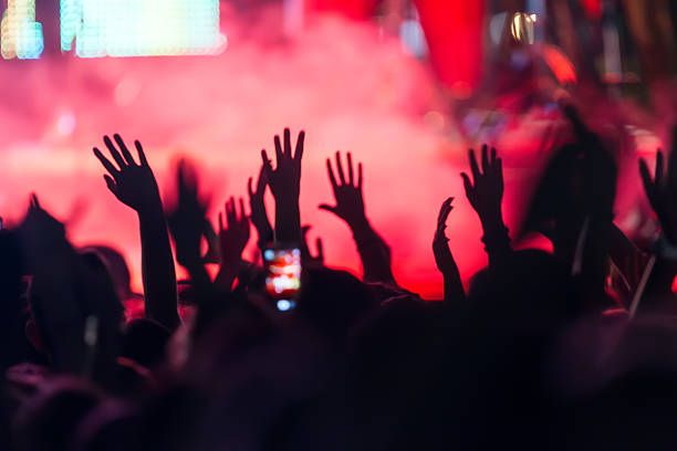 istock People taking photographs with touch smart phone during a music 468984498
