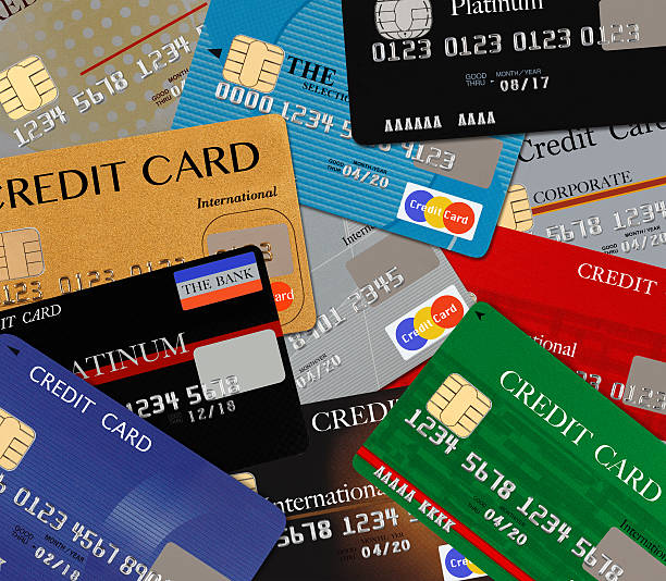 Pile of different multicolored credit cards background