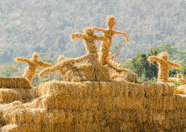 New Holland, Pennsylvania  - August 4, 2017: Two young Mennonite girls with a water pail carry water for the hay crew at Big Spring Farm Days. This is an annual event demonstrating traditional threshing and harvesting methods, using restored antique and vintage tools.