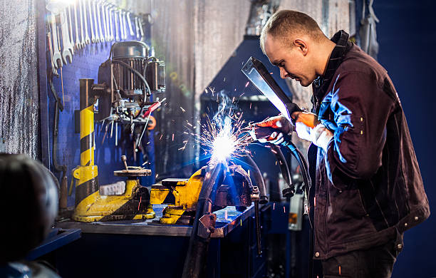 istock Mechanical carefully welding the tube 468985736