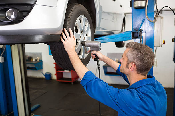istock Mechanic adjusting the tire wheel 468986244