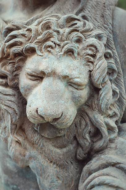 istock Lion sculptures spraying water on wall background 468986588