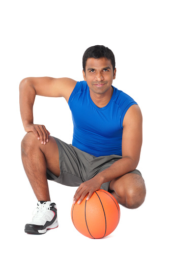 Basketball. Professional basketball player standing with the ball in his hand. On a white background. Back view. Sport. Isolated