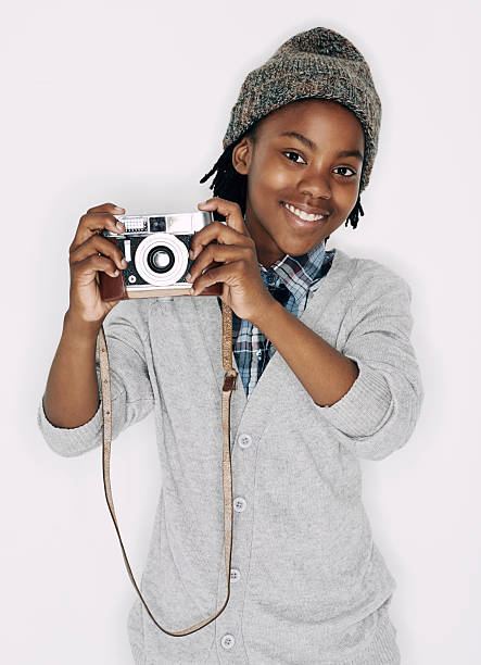A young boy taking snapshots with his camera