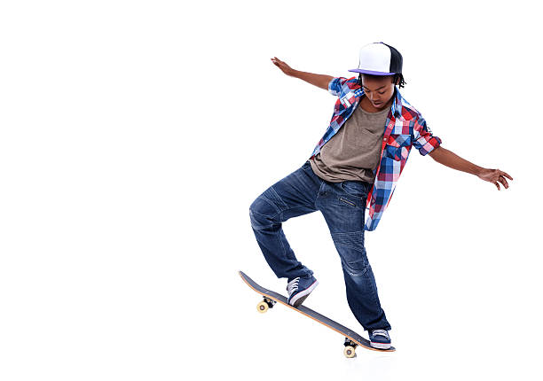 Born to board! An African-American boy doing a trick on his skateboard Ollie stock pictures, royalty-free photos & images