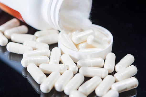 istock Closeup of Plenty White Pills Placed Bulk 468989386