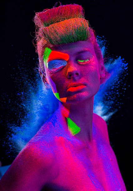 istock Women Portrait with Glowing makeup in black light 468990885