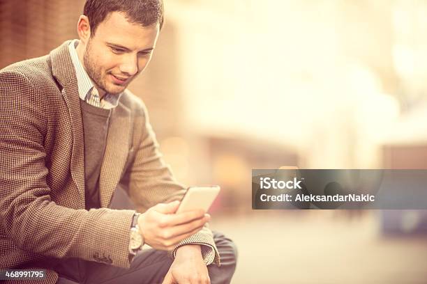 Smiling Man Using A Smartphone On The Street Stock Photo - Download Image Now - 25-29 Years, Adult, Adults Only