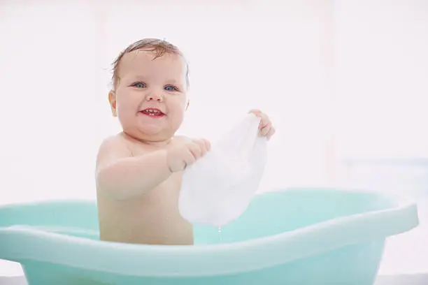 A cute baby having fun in the bathtub