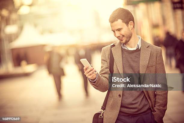 Smiling Man Using A Smartphone On The Street Stock Photo - Download Image Now - 25-29 Years, Adult, Adults Only