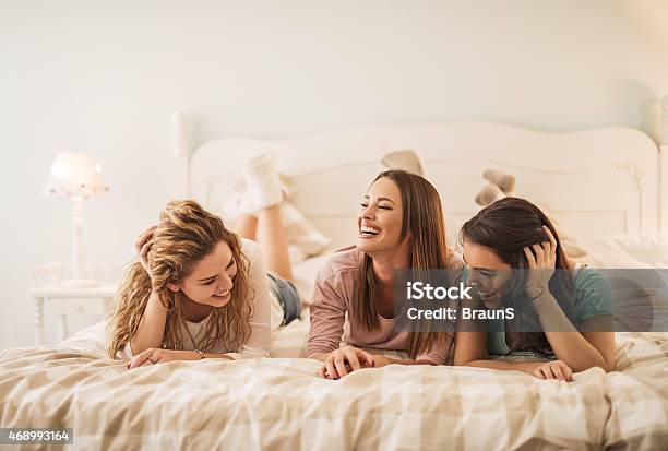 Women Having Fun In Bedroom While Talking To Each Other Stock Photo - Download Image Now