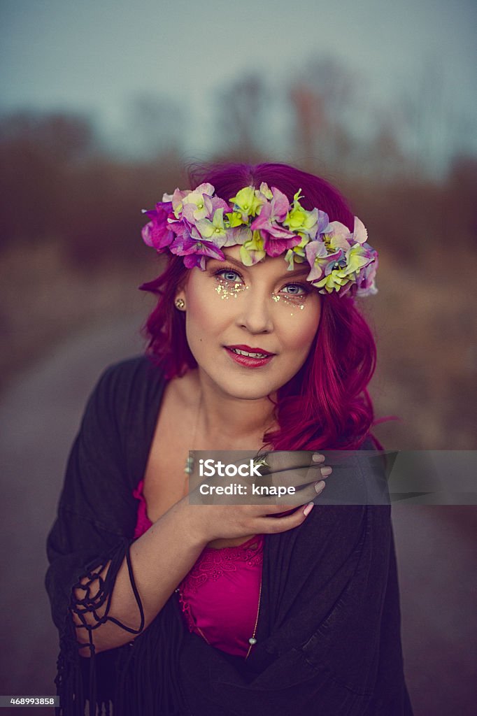 Beautiful woman with pink hair and flower garland Beautiful woman with long pink hair and glitter make up and flower garland 18-19 Years Stock Photo