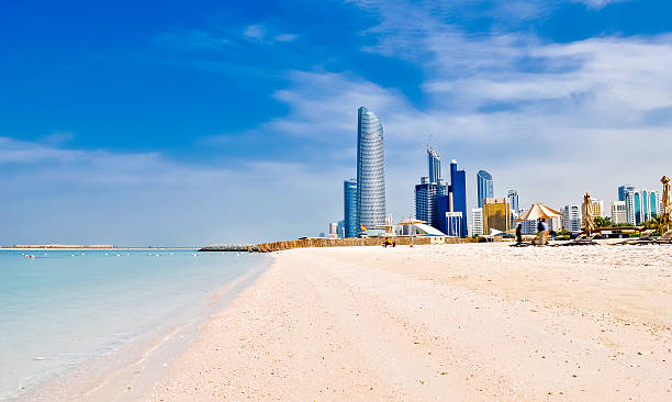 beach in Abu Dhabi, UAE sunny beach and cityscape in Abu Dhabi, UAE abu dhabi stock pictures, royalty-free photos & images