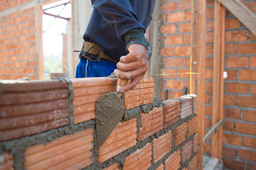 Worker building masonry house wal