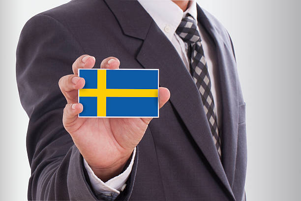 istock holding a business card with Sweden Flag 468997735
