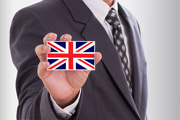 istock holding a business card with UK flag 468997859