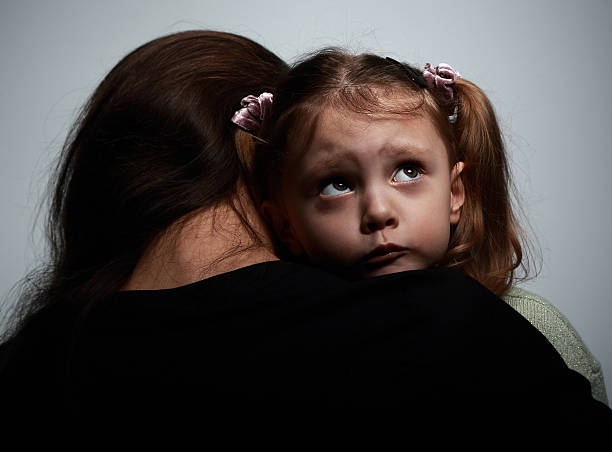 istock Thinking sad daughter embracing her mother and looking up 468999222