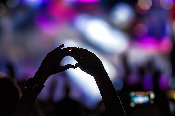 istock People taking photographs with touch smart phone during a music 469000422